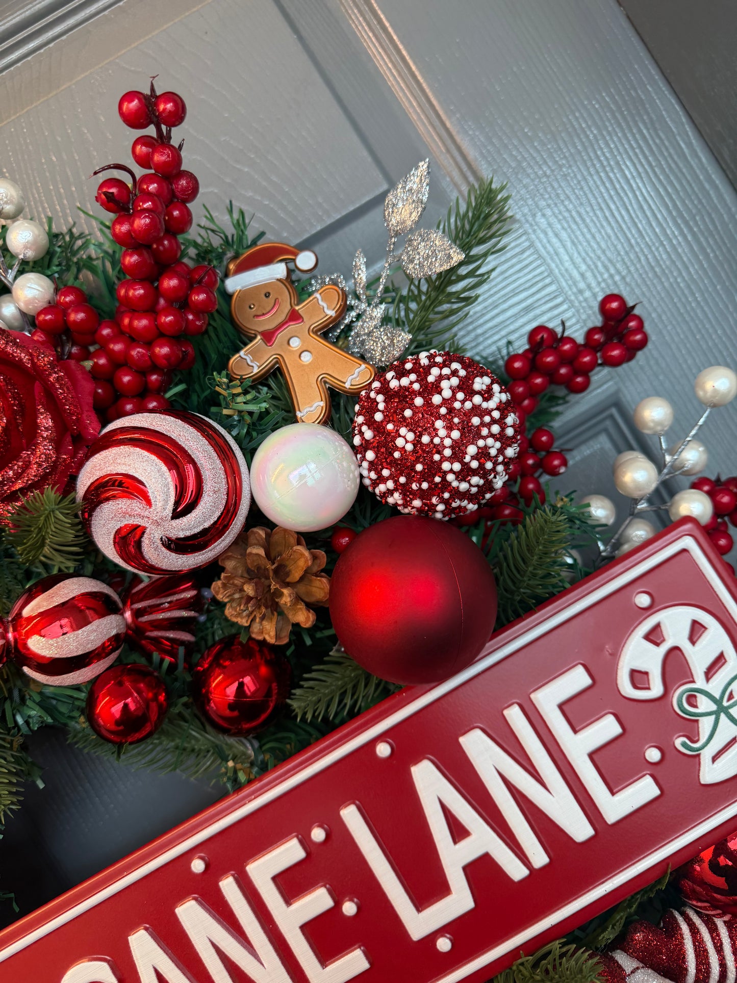 Candy Cane Lane Christmas Artificial Wreath – Gingerbread & Candy Theme Door Decor – Red & White Holiday Wreath with Baubles, Berries, Roses & Sign